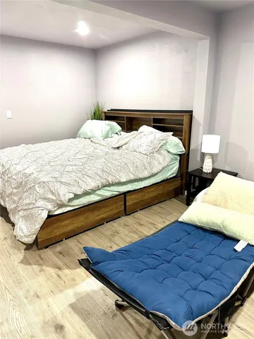 a bed sitting in a bedroom and lamp