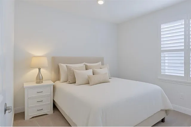 a bedroom with a bed and a night stand