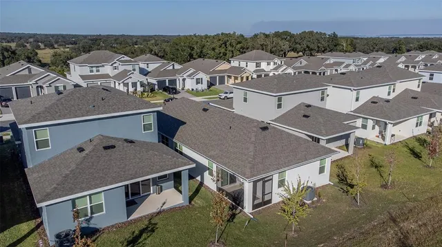an aerial view of a houses with a city