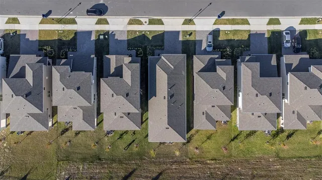 an aerial view of residential houses with outdoor space