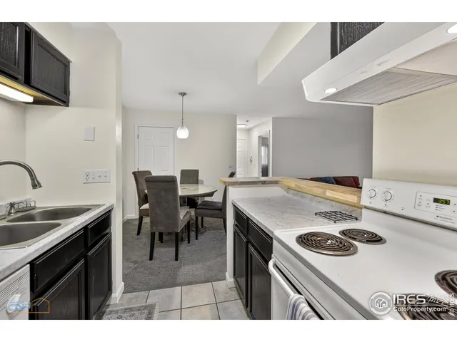 a kitchen with a stove a sink and a refrigerator