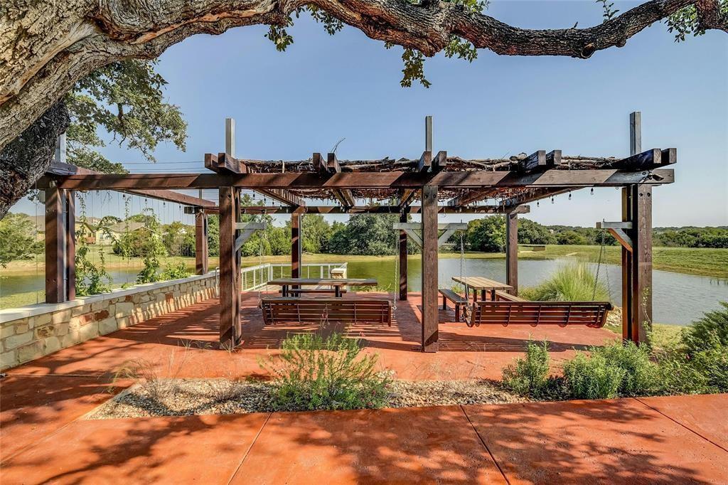736 Bonnet Boulevard Georgetown, TX 78628 - Photo 22 of 27 a view of a patio with a table chairs and a backyard