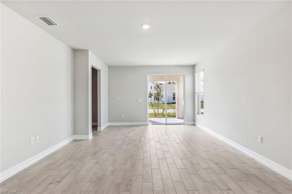 826 Friendship Circle LaBelle, FL 33935 - Photo 18 of 19 wooden floor in an empty room with a window