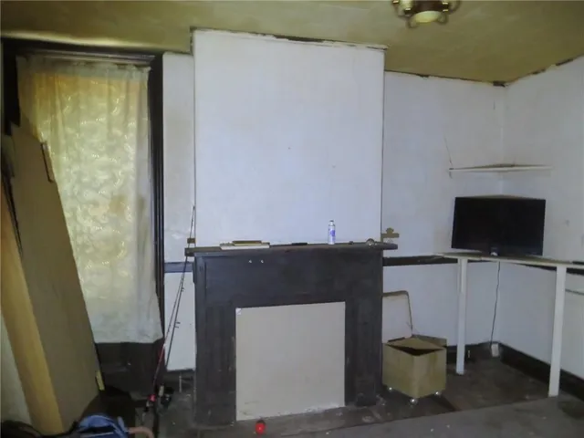 a room with a chair and a flat screen tv