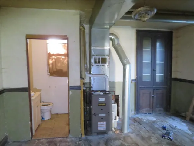 a view of a hallway with toilet and sink