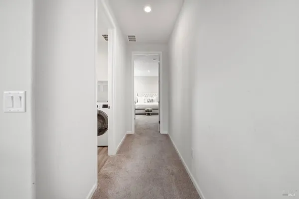 a view of a hallway with wooden floor