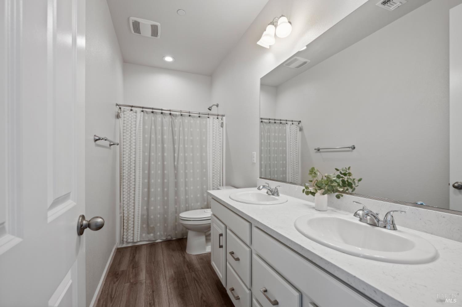 2148 Karen Place Rohnert Park, CA 94928 - Photo 20 of 25 a bathroom with a double vanity sink toilet and a mirror
