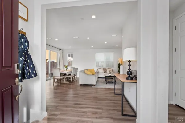 a living room with furniture and wooden floor