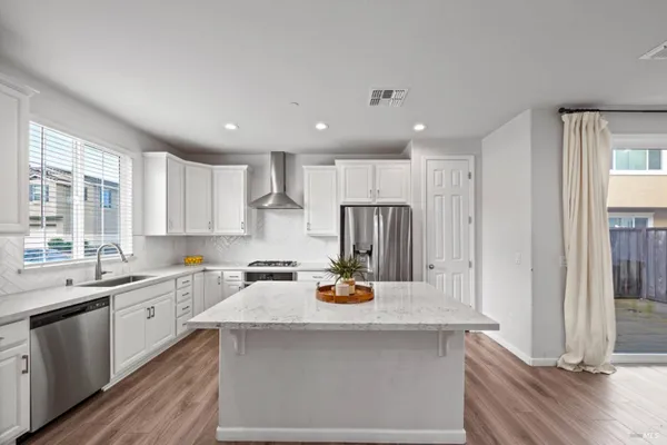 a kitchen with a sink a refrigerator and window