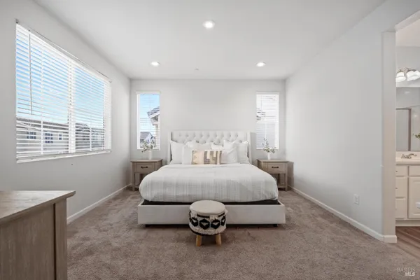 a spacious bedroom with a bed and a window