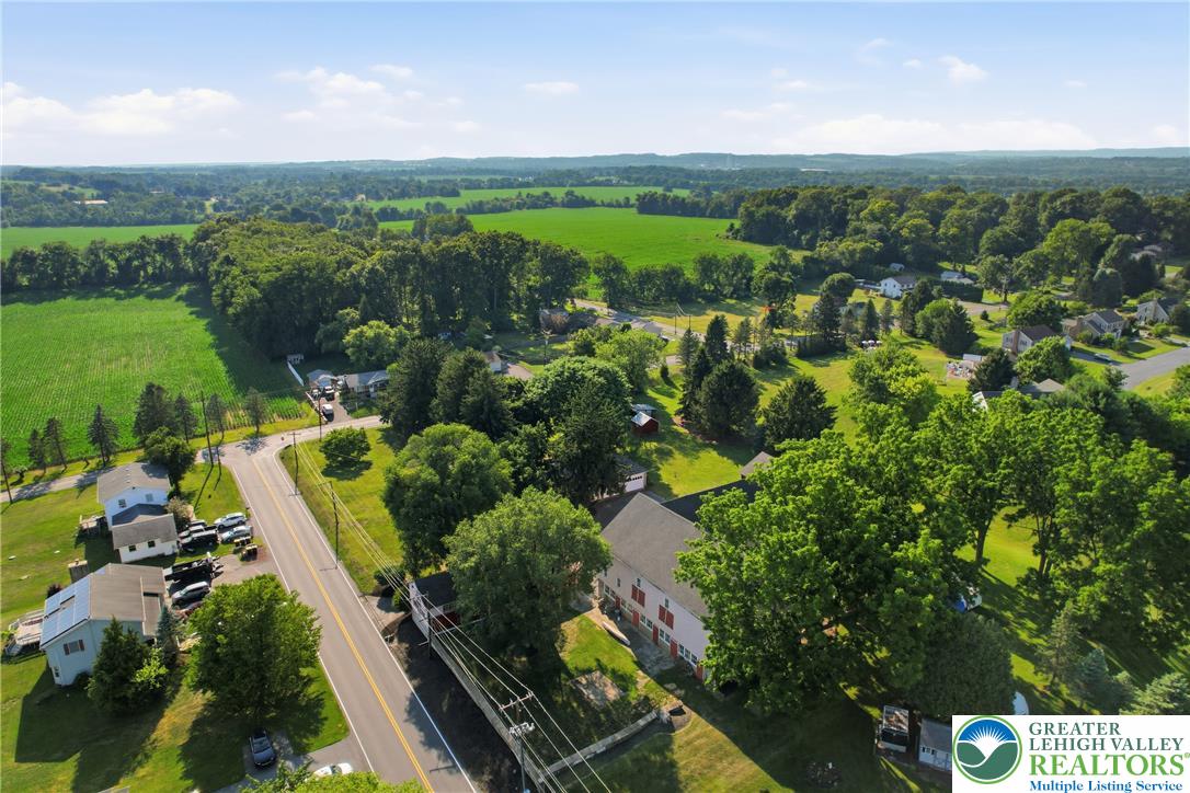 4682 Steuben Road Bethlehem, PA 18020 - Photo 72 of 79 An aerial panorama reveals a harmonious blend of residential properties and lush, verdant agricultural fields.