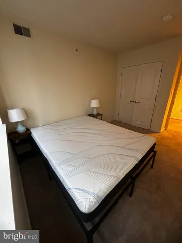 a living room with a bed furniture and a window