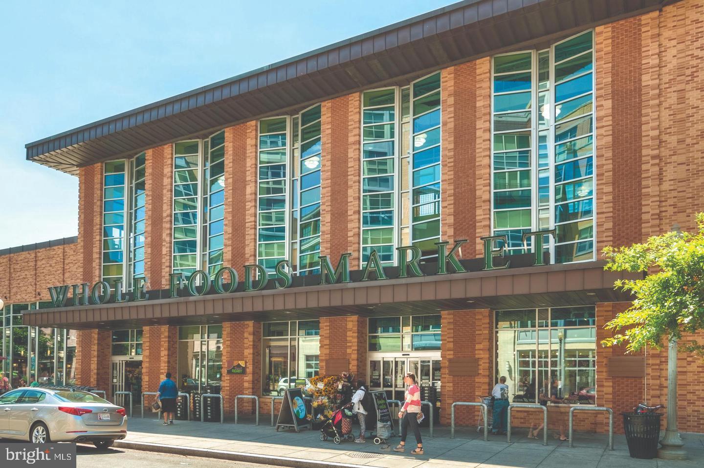 1225 13th Street Northwest, Unit 712 Washington, DC 20005 - Photo 21 of 21 Vibrant Whole Foods Market entrance bustling wi...