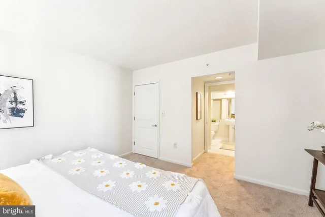 a bedroom with a bed and hallway