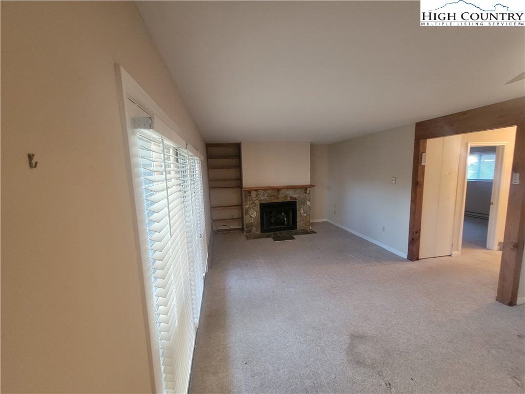 471 Kellwood Drive Extension, Unit 2N1 Boone, NC 28607 - Photo 3 of 6 a view of empty room with fireplace and window