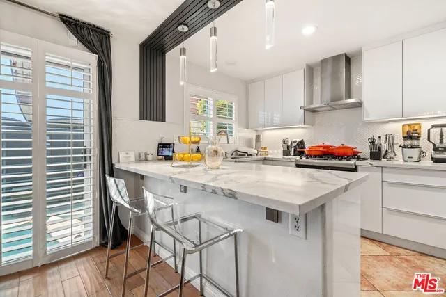a kitchen with stainless steel appliances granite countertop a sink and cabinets
