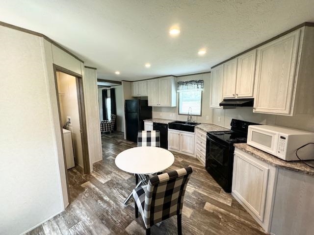 100 Rich Road Somerville, TN 38068 - Photo 9 of 20 a kitchen with a table chairs refrigerator and microwave