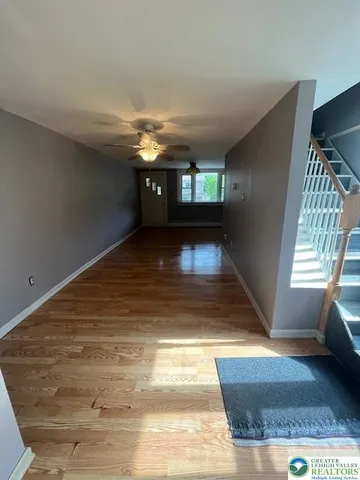 a view of entryway window and wooden floor