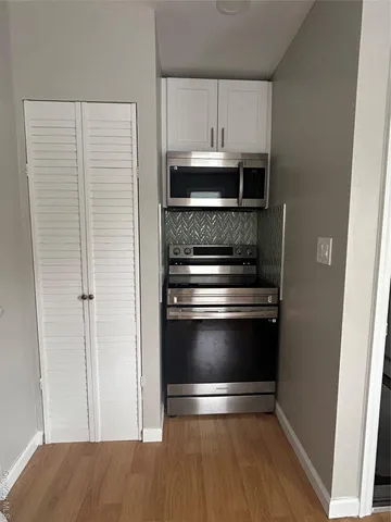 a kitchen with appliances and cabinets