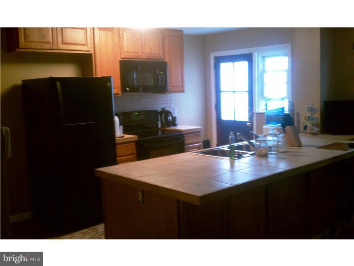 256 Glendale Road Upper Darby, PA 19082 - Photo 13 of 13 a kitchen with a sink refrigerator and microwave