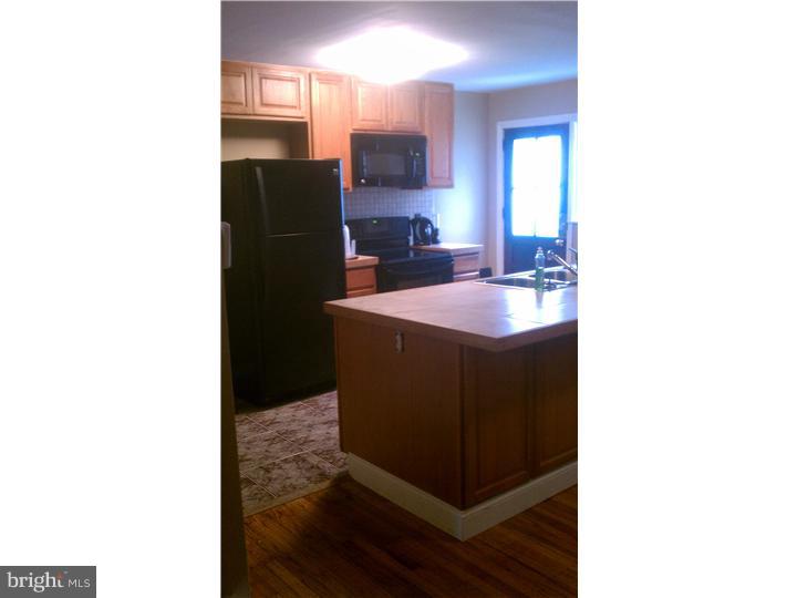 256 Glendale Road Upper Darby, PA 19082 - Photo 8 of 13 a kitchen with a sink and a refrigerator