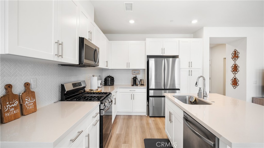 3610 East Pollock Street, Unit 4 Ontario, CA 91761 - Photo 15 of 47 a kitchen with a sink a stove and refrigerator