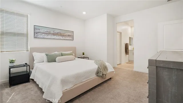 a bedroom with a bed and a couch