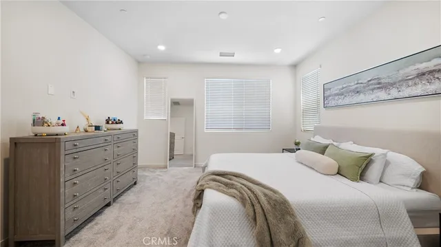 a bedroom with a large bed and a window