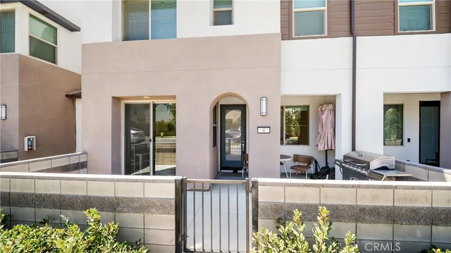 a front view of a house with lots of potted plants