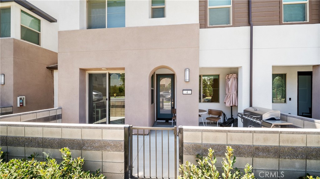 3610 East Pollock Street, Unit 4 Ontario, CA 91761 - Photo 2 of 47 a front view of a house with lots of potted plants