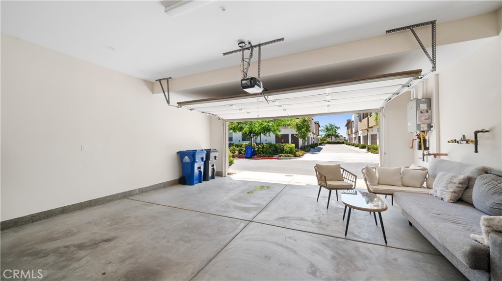 3610 East Pollock Street, Unit 4 Ontario, CA 91761 - Photo 30 of 47 a living room with couches a dining table and chairs with outer view