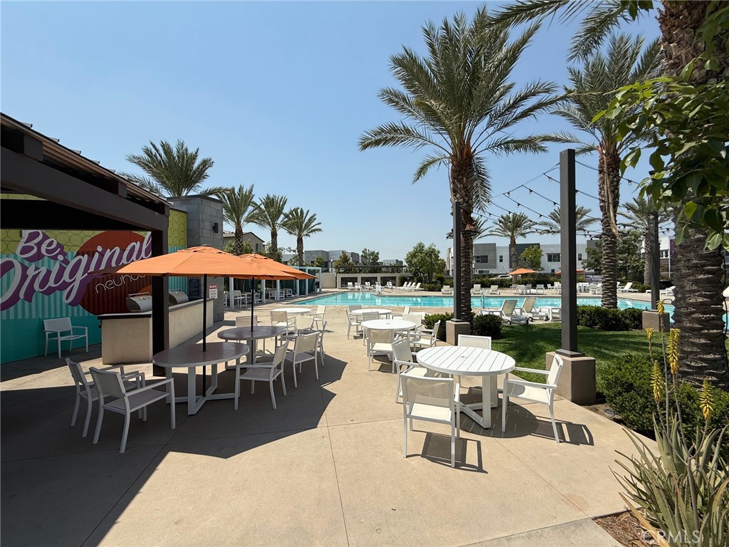 3610 East Pollock Street, Unit 4 Ontario, CA 91761 - Photo 40 of 47 a patio with a table and chairs under an umbrella
