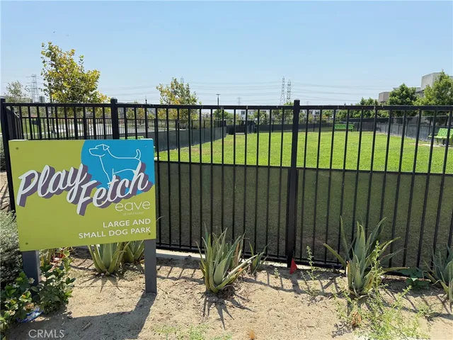 a view of a park with a bench and trees
