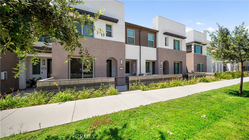 3610 East Pollock Street, Unit 4 Ontario, CA 91761 - Photo 5 of 47 a view of a white house with a yard and plants