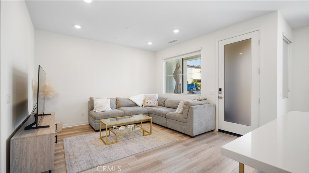 3610 East Pollock Street, Unit 4 Ontario, CA 91761 - Photo 8 of 47 a living room with furniture and a flat screen tv