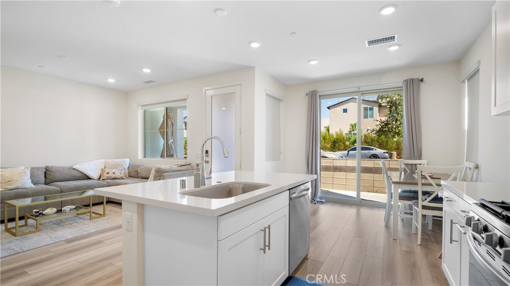 3610 East Pollock Street, Unit 4 Ontario, CA 91761 - Photo 10 of 47 a living room with furniture and a flat screen tv