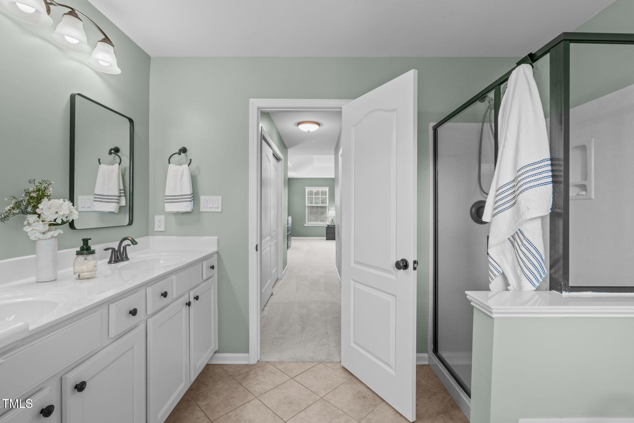 1909 Ferntree Court Morrisville, NC 27560 - Photo 19 of 38 a bathroom with a double vanity sink and mirror