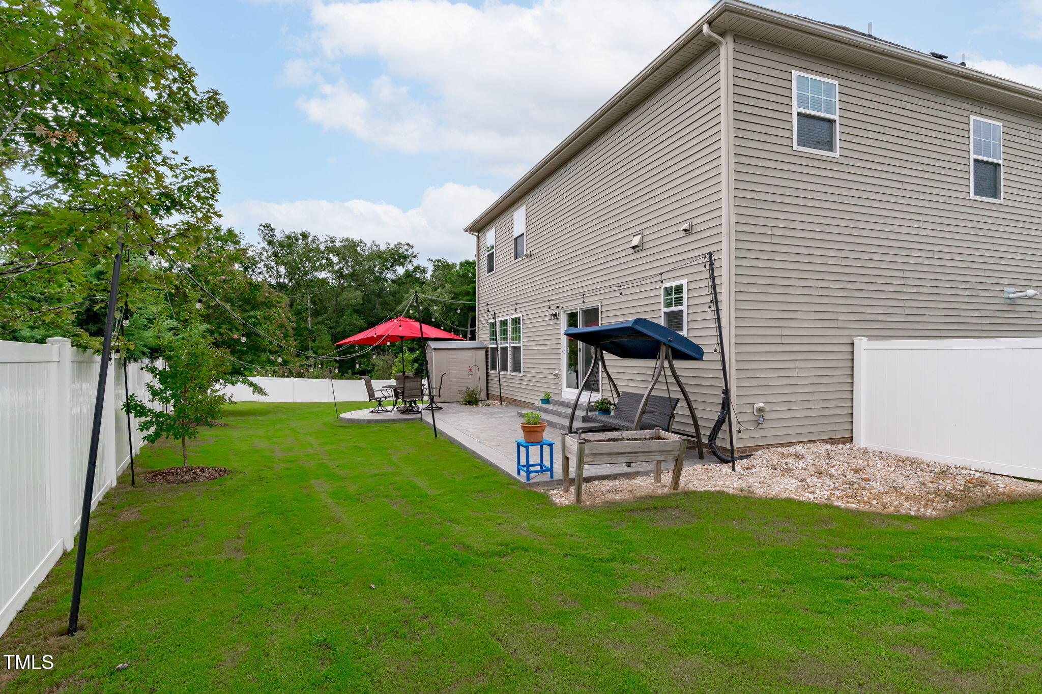1909 Ferntree Court Morrisville, NC 27560 - Photo 29 of 38 a view of a patio with a table and chairs under an umbrella