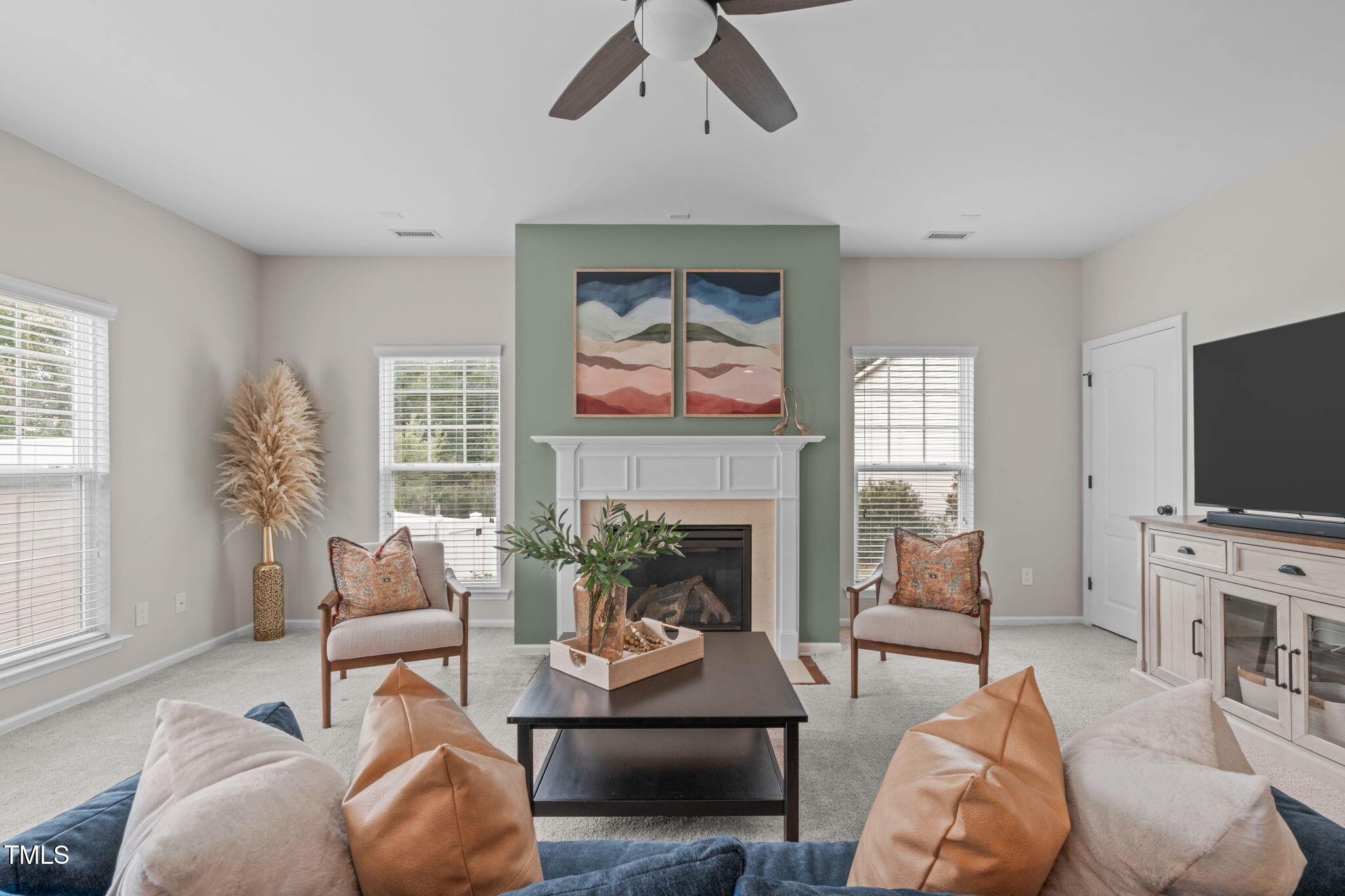 1909 Ferntree Court Morrisville, NC 27560 - Photo 5 of 38 a living room with furniture a fireplace and a flat screen tv