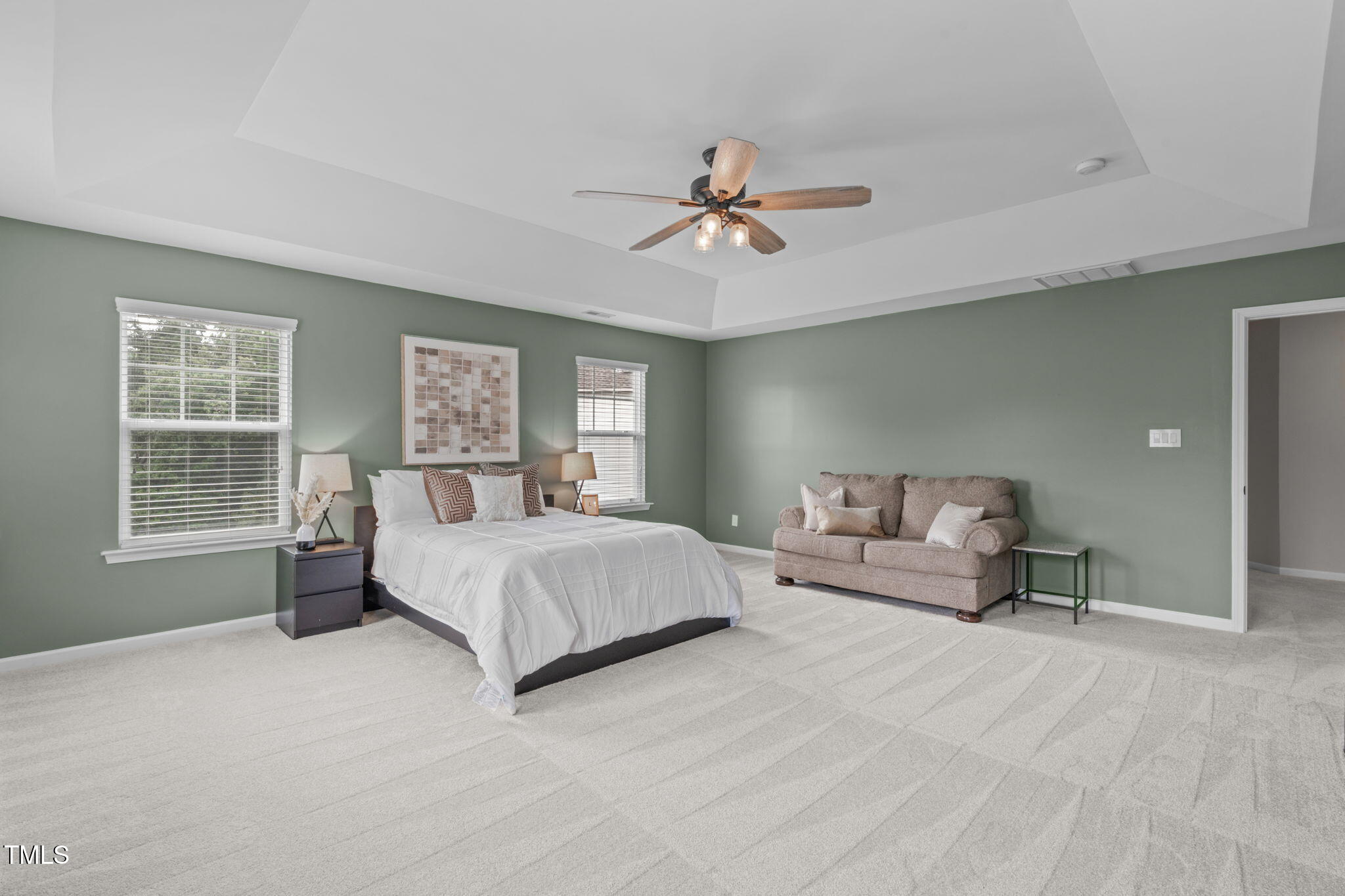 1909 Ferntree Court Morrisville, NC 27560 - Photo 6 of 38 a spacious bedroom with a large bed and a chandelier