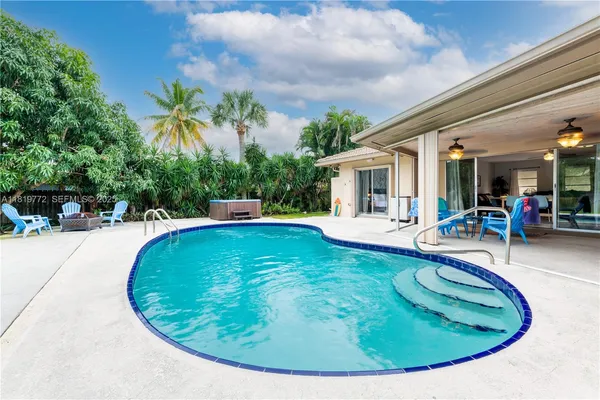 a view of a swimming pool with outdoor seating