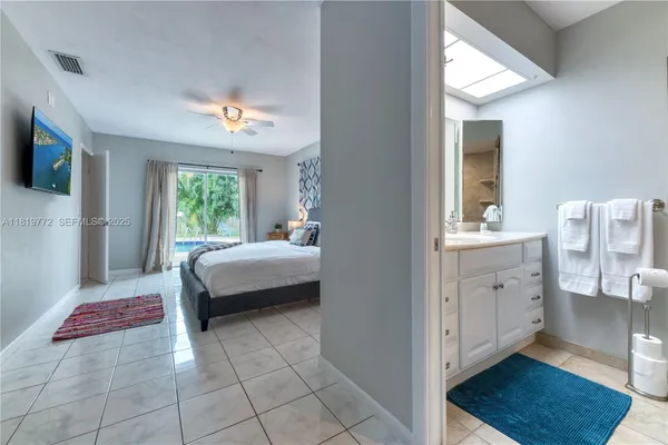 a spacious bedroom with a bed and a view of bathroom