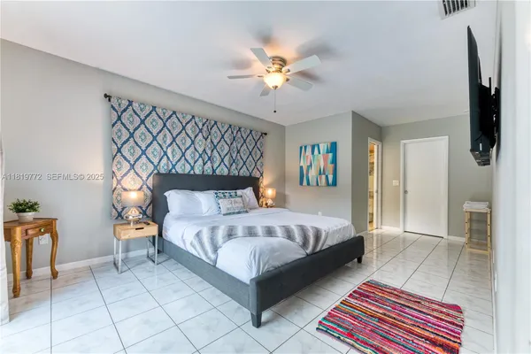 a bed room with a bed and a chandelier