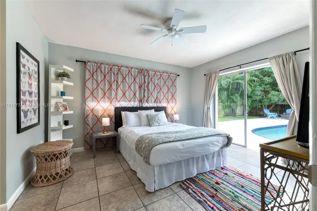 a bedroom with a bed chair and a large window