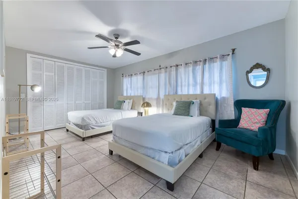 a spacious bedroom with a bed and window