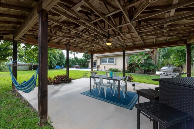 a view of a porch with furniture and garden