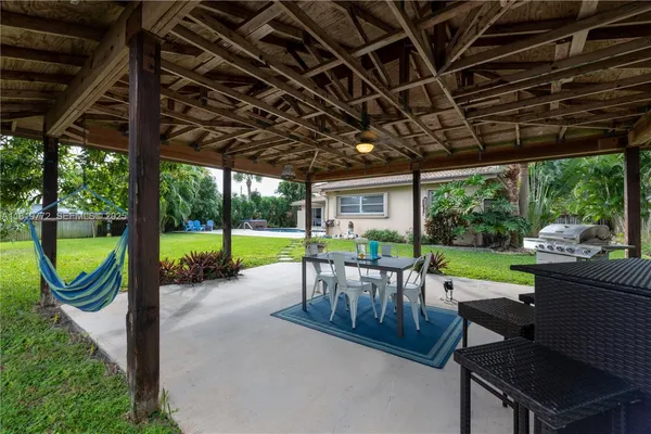 a view of a patio with a table chairs and a backyard