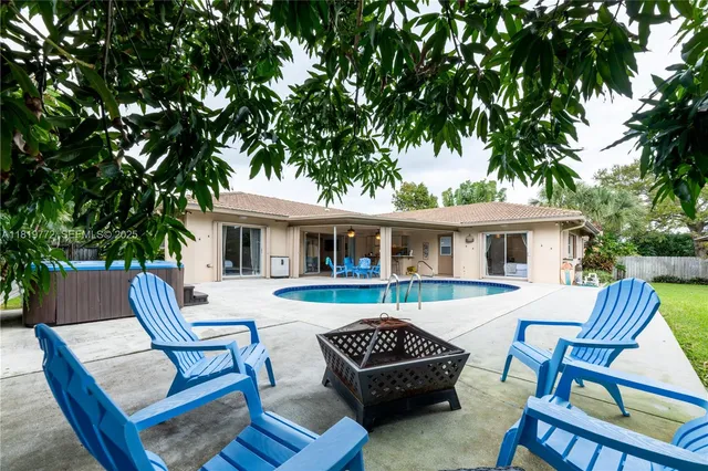 a view of house with a barbeque grill and a fire pit