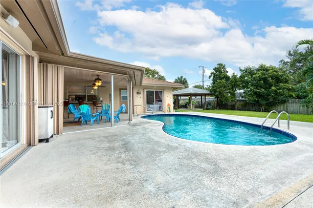 view of pool with brick walls