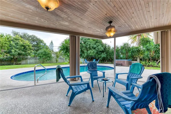 a view of a patio with a table chairs and backyard